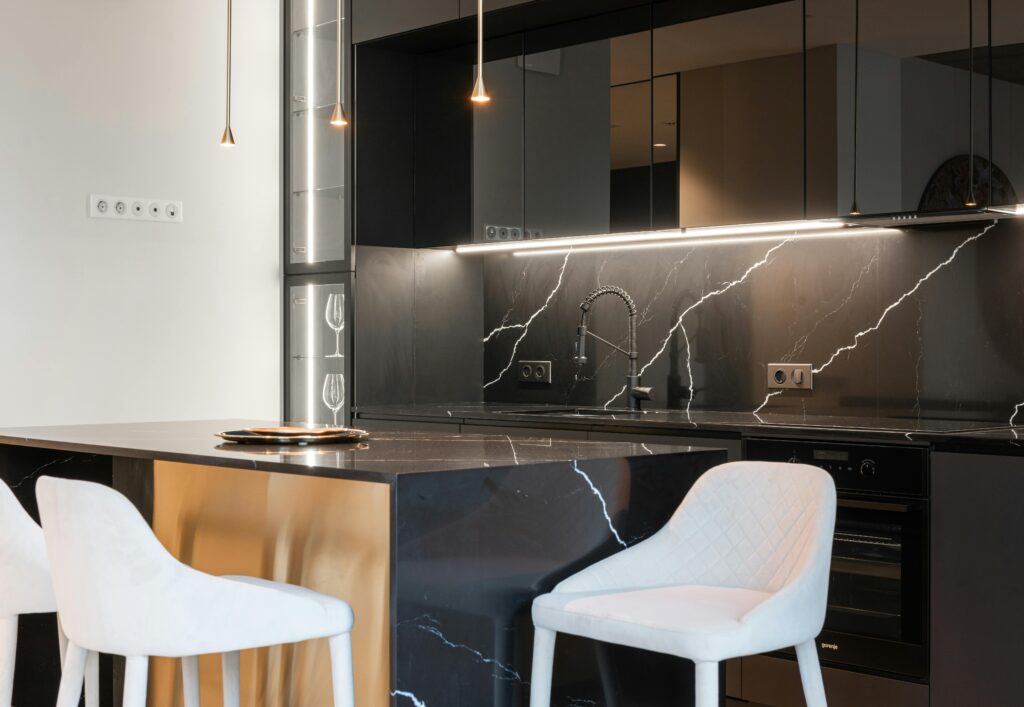 Sleek and sophisticated black marble kitchen with minimalist design, highlighting elegance and functionality.